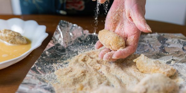 senior-woman-coating-croquettes-with-breadcrumbs-a-2025-01-08-17-25-03-utc-min